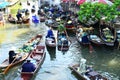 AMPHAWA Ã¢â¬â APRIL 29: Wooden boats are loaded with fruits from the orchards at Tha kha floating market Royalty Free Stock Photo